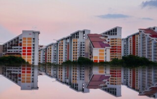 Singapore HDB blocks reflected in water at dusk