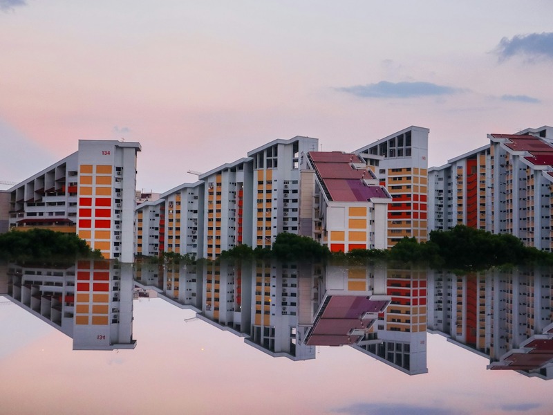Singapore HDB blocks reflected in water at dusk