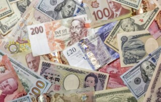 Japanese yen and US dollar banknotes among a collection of international currencies
